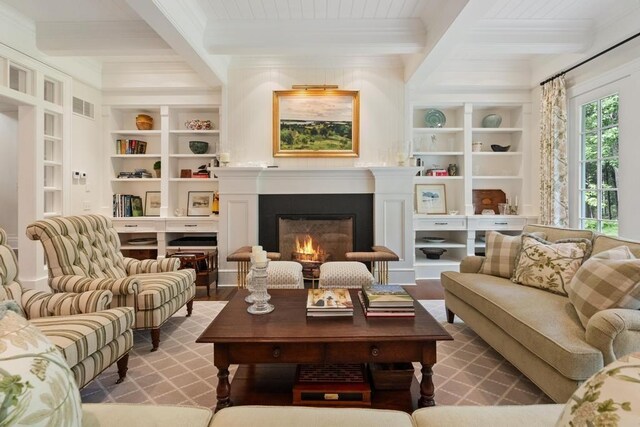 145 Traverse St, Harbor Springs, MI 49740 - living area with ornamental molding, a lit fireplace, beam ceiling, built in features, and coffered ceiling
