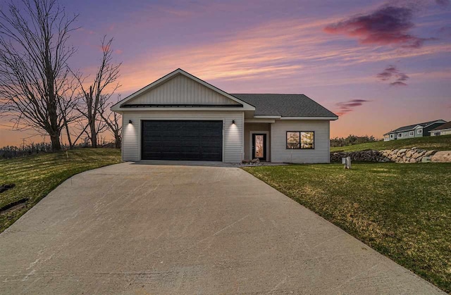 705 Maple Crk, Petoskey, MI 49770 - view of front of property featuring driveway, a yard, and an attached garage