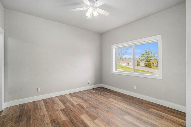 705 Maple Crk, Petoskey, MI 49770 - empty room with wood finished floors and a ceiling fan