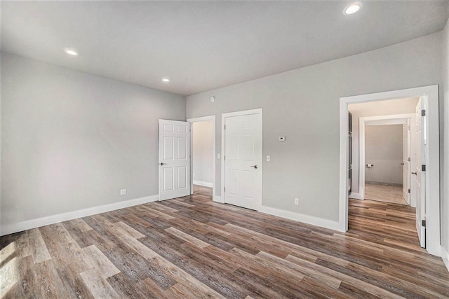 705 Maple Crk, Petoskey, MI 49770 - unfurnished bedroom featuring wood finished floors and recessed lighting