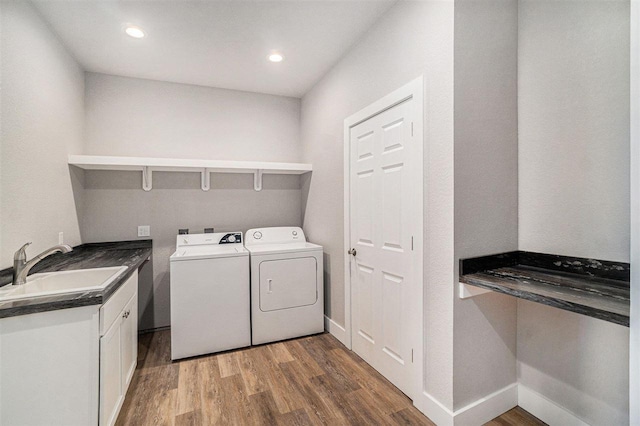 705 Maple Crk, Petoskey, MI 49770 - washroom featuring independent washer and dryer, wood finished floors, recessed lighting, and cabinet space