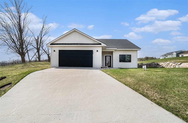 705 Maple Crk, Petoskey, MI 49770 - modern farmhouse style home with an attached garage, concrete driveway, and a front lawn