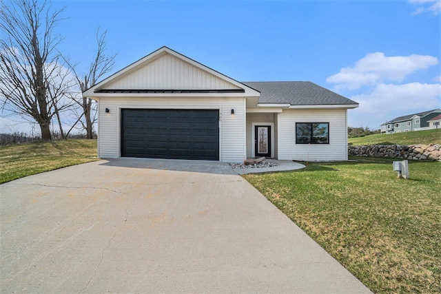 705 Maple Crk, Petoskey, MI 49770 - view of front of home with driveway, a garage, a front lawn, and board and batten siding
