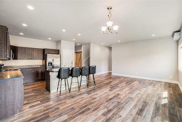 705 Maple Crk, Petoskey, MI 49770 - kitchen featuring stainless steel fridge, wood finished floors, a breakfast bar area, dark brown cabinets, and recessed lighting
