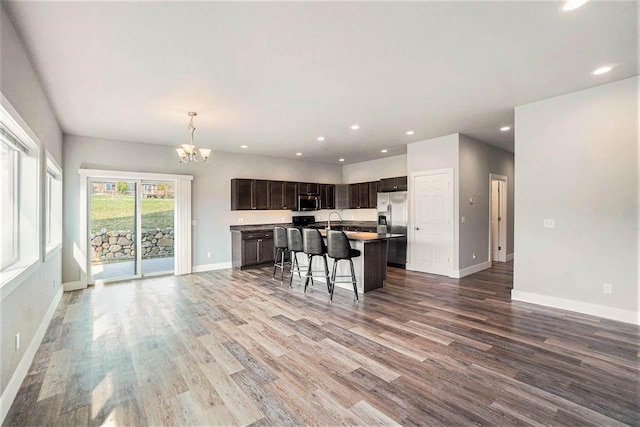 705 Maple Crk, Petoskey, MI 49770 - kitchen featuring appliances with stainless steel finishes, open floor plan, wood finished floors, a chandelier, and recessed lighting