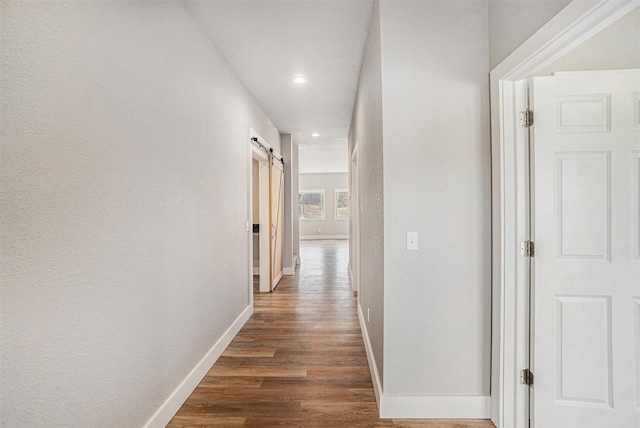 705 Maple Crk, Petoskey, MI 49770 - corridor with a barn door, dark wood-style floors, and recessed lighting