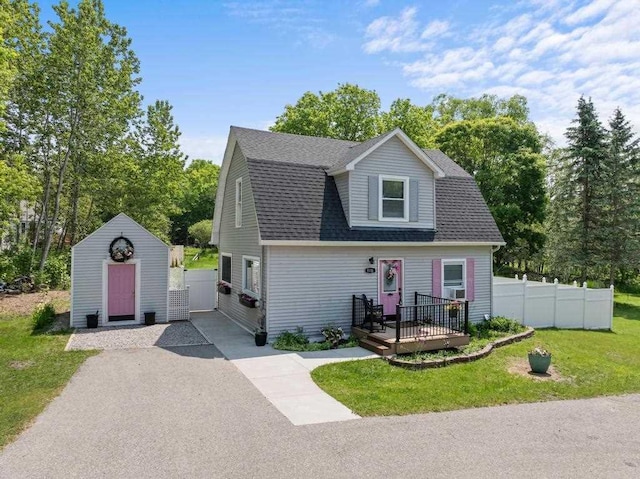 1116 N Lake St, Boyne City, MI 49712 - dutch colonial with a deck, roof with shingles, and a storage unit