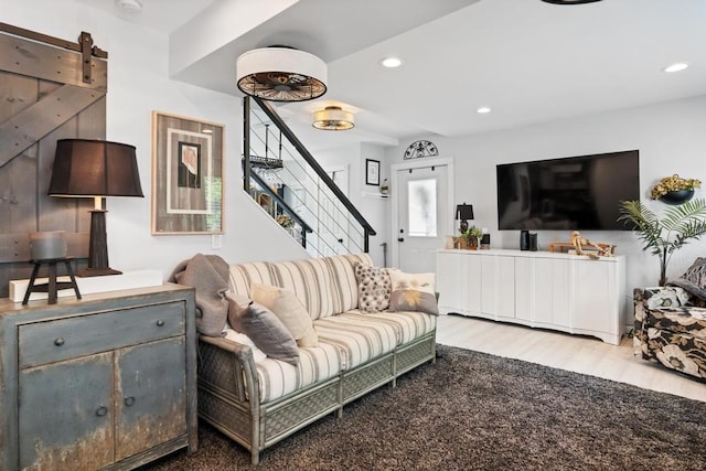 1116 N Lake St, Boyne City, MI 49712 - living room featuring stairway, wood finished floors, and recessed lighting