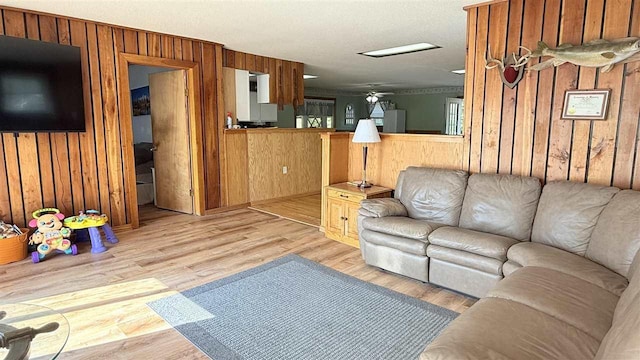 2160 Kladder Rd, Bellaire, MI 49615 - living area featuring wood walls, light wood finished floors, and ceiling fan