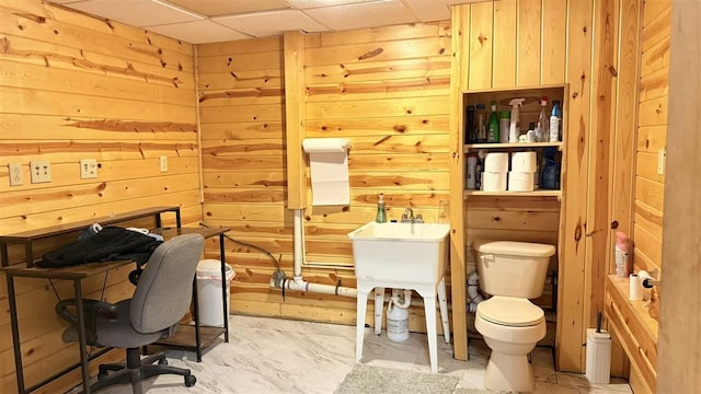 2160 Kladder Rd, Bellaire, MI 49615 - home office featuring wooden walls, a drop ceiling, and concrete floors