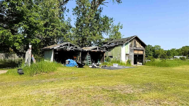 2160 Kladder Rd, Bellaire, MI 49615 - back of house featuring a yard and an attached garage