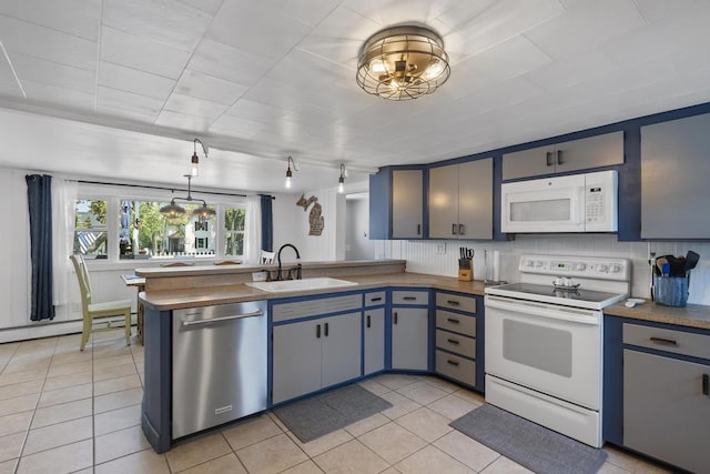 424 Carleton, Petoskey, MI 49770 - kitchen featuring white appliances, a peninsula, light tile patterned floors, baseboard heating, and blue cabinetry