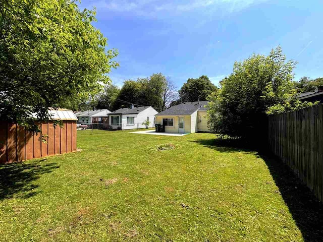 2343 Bonner Rd, Ferndale, MI 48220 - fenced backyard with a patio area and a storage unit
