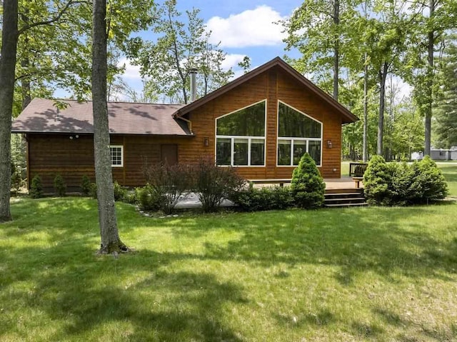 6989 Meadowlark Way, Gaylord, MI 49735 - back of property with a wooden deck and a yard
