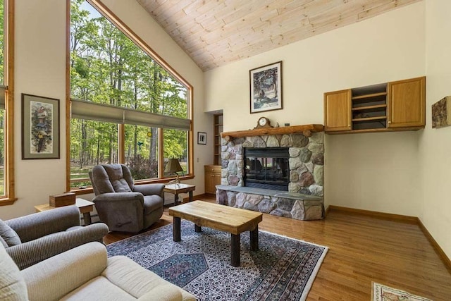 6989 Meadowlark Way, Gaylord, MI 49735 - living room featuring a fireplace, wood finished floors, and high vaulted ceiling