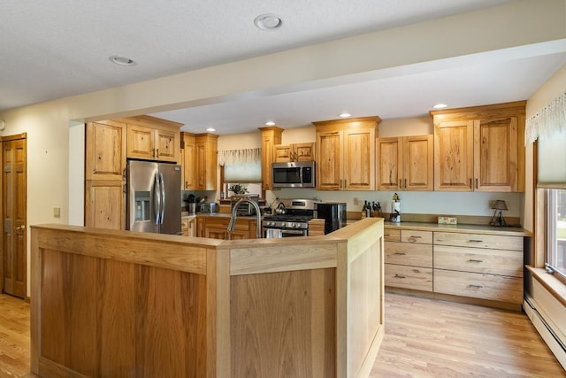 6989 Meadowlark Way, Gaylord, MI 49735 - kitchen featuring stainless steel appliances, a baseboard heating unit, light wood finished floors, recessed lighting, and light brown cabinets