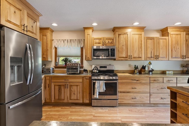 6989 Meadowlark Way, Gaylord, MI 49735 - kitchen featuring stainless steel appliances, light wood finished floors, recessed lighting, and light brown cabinets