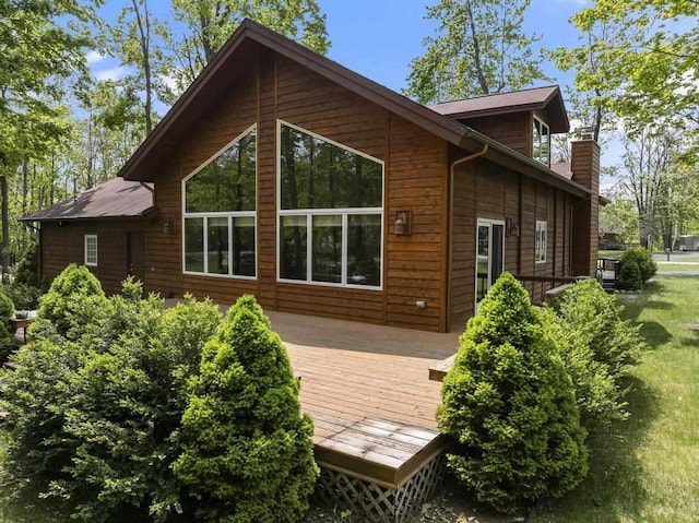 6989 Meadowlark Way, Gaylord, MI 49735 - back of property featuring a deck and a chimney