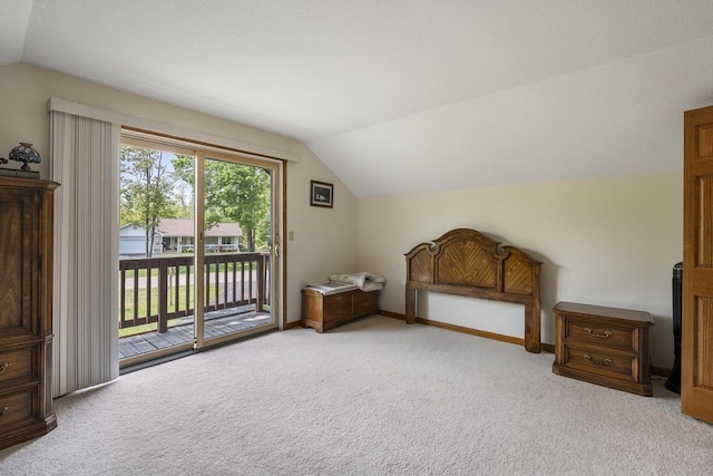 6989 Meadowlark Way, Gaylord, MI 49735 - unfurnished bedroom with vaulted ceiling, access to exterior, and carpet floors