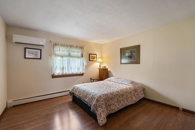 6989 Meadowlark Way, Gaylord, MI 49735 - bedroom with a baseboard heating unit, a wall unit AC, and wood finished floors