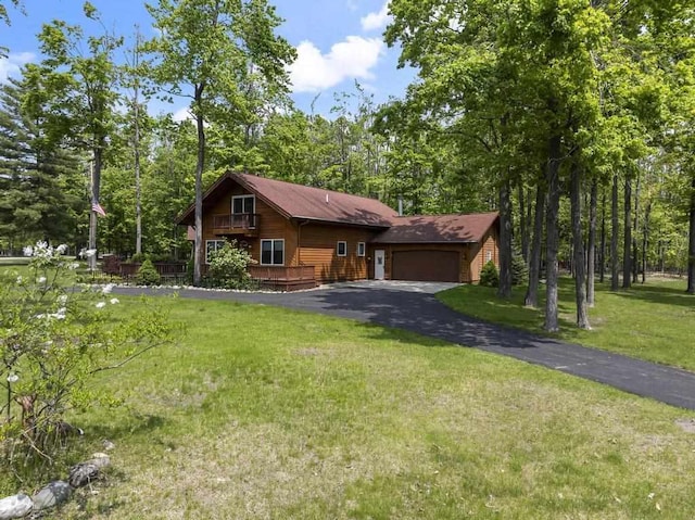 6989 Meadowlark Way, Gaylord, MI 49735 - view of front of property featuring a front lawn, an attached garage, and asphalt driveway