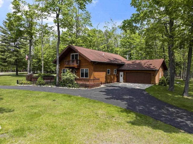 6989 Meadowlark Way, Gaylord, MI 49735 - view of front facade featuring an attached garage, driveway, a front lawn, and a wooden deck