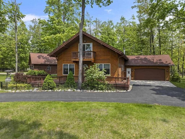6989 Meadowlark Way, Gaylord, MI 49735 - chalet / cabin with an attached garage, driveway, a balcony, and a front lawn