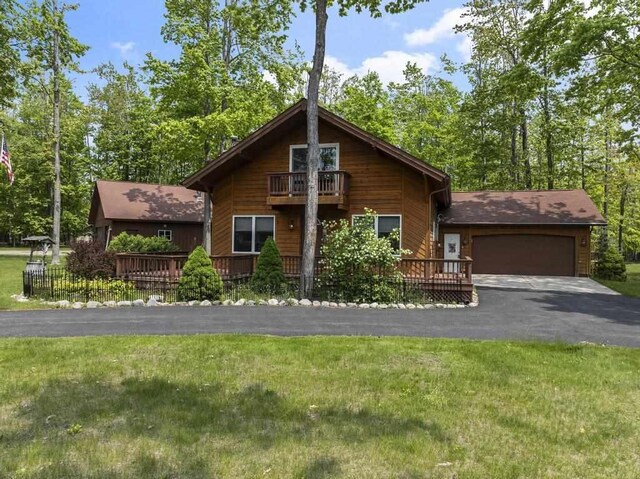 6989 Meadowlark Way, Gaylord, MI 49735 - rustic home featuring a balcony, an attached garage, a front lawn, and driveway