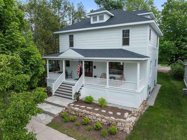 606 State St, Petoskey, MI 49770 - american foursquare style home with covered porch, roof with shingles, and stairway