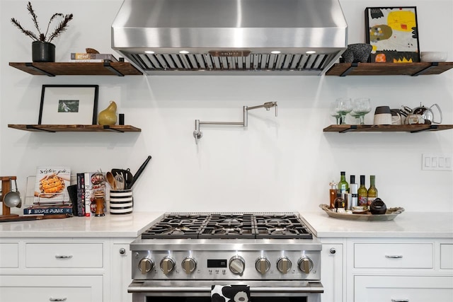 606 State St, Petoskey, MI 49770 - kitchen featuring island exhaust hood, open shelves, stainless steel gas range, white cabinets, and light countertops