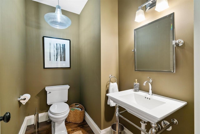 606 State St, Petoskey, MI 49770 - half bathroom with toilet and wood finished floors
