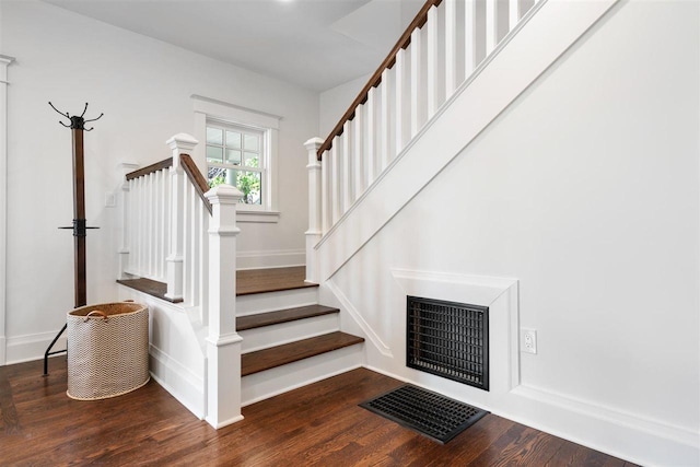 606 State St, Petoskey, MI 49770 - staircase featuring wood finished floors and baseboards