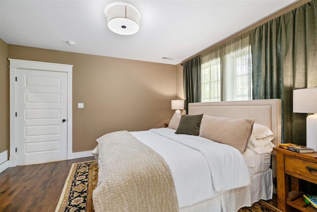 606 State St, Petoskey, MI 49770 - bedroom with dark wood finished floors and radiator