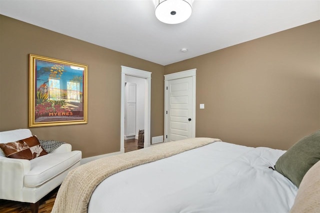 606 State St, Petoskey, MI 49770 - bedroom with dark wood-type flooring and baseboards