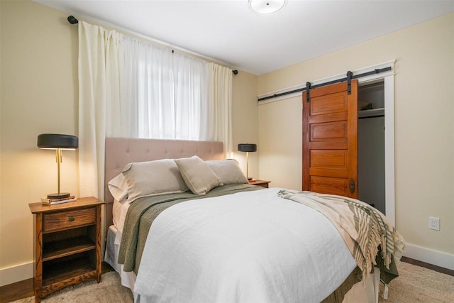 606 State St, Petoskey, MI 49770 - bedroom with a barn door and baseboards