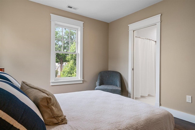 606 State St, Petoskey, MI 49770 - bedroom featuring dark wood-style floors and baseboards