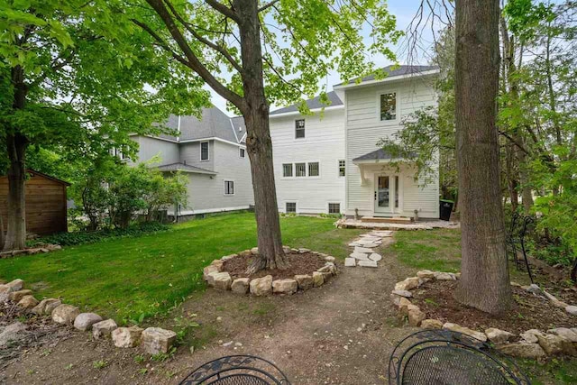 606 State St, Petoskey, MI 49770 - back of house featuring a yard