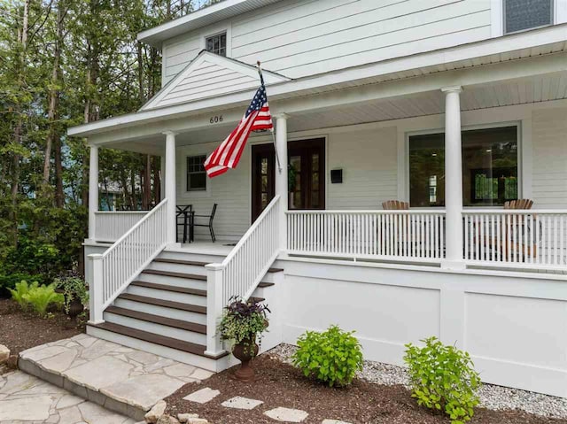 606 State St, Petoskey, MI 49770 - view of front of house with a porch and stairway