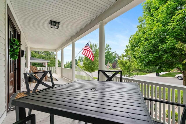 606 State St, Petoskey, MI 49770 - wooden porch featuring outdoor dining area