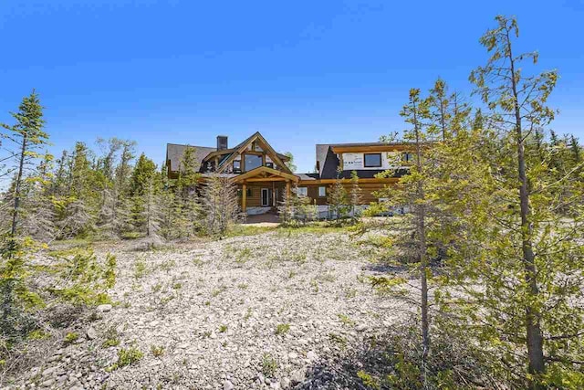 7177 Albany Point Rd, Presque Isle, MI 49777 - back of house with a chimney