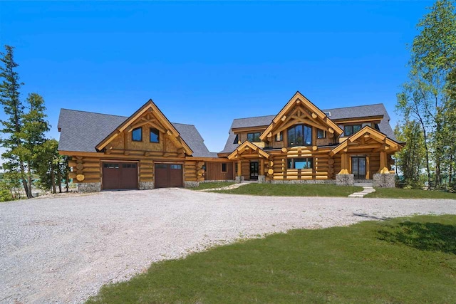 7177 Albany Point Rd, Presque Isle, MI 49777 - log home featuring log exterior, gravel driveway, a front lawn, stone siding, and an attached garage