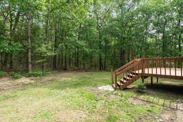 3049 Chippewa Beach Rd, Indian River, MI 49749 - view of grassy yard featuring a wooden deck, a forest view, and stairway
