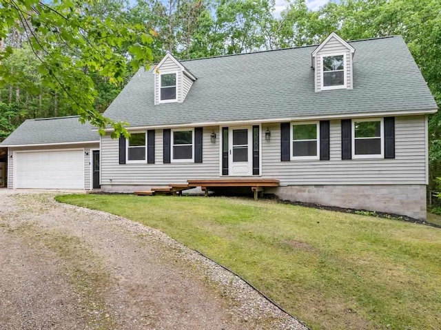 3049 Chippewa Beach Rd, Indian River, MI 49749 - cape cod house featuring driveway, a garage, a front yard, and roof with shingles