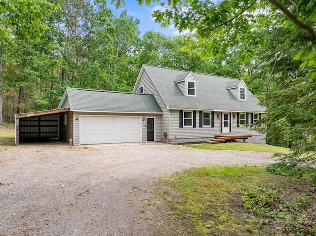 3049 Chippewa Beach Rd, Indian River, MI 49749 - new england style home with driveway, a garage, and roof with shingles