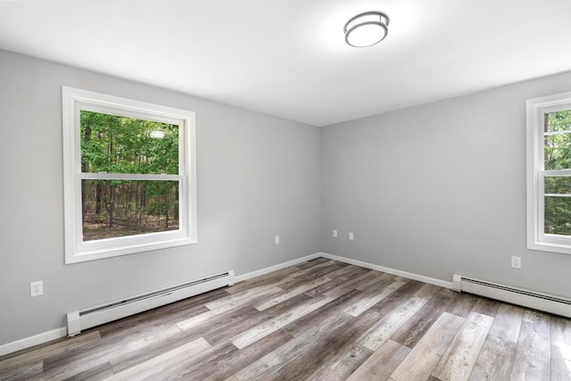 3049 Chippewa Beach Rd, Indian River, MI 49749 - spare room featuring baseboard heating and wood finished floors