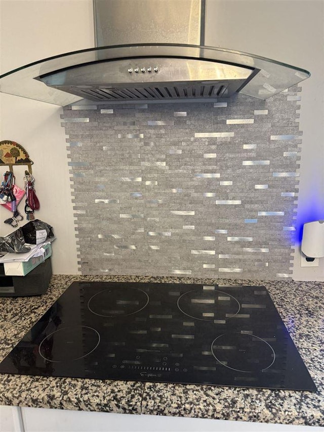 6515 Pincherry Rd, Charlevoix, MI 49720 - kitchen view of black electric cooktop and wall chimney range hood