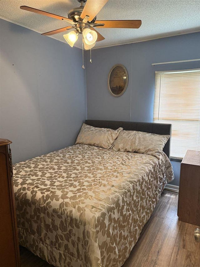6515 Pincherry Rd, Charlevoix, MI 49720 - bedroom featuring wood-type flooring, a textured ceiling, and ceiling fan