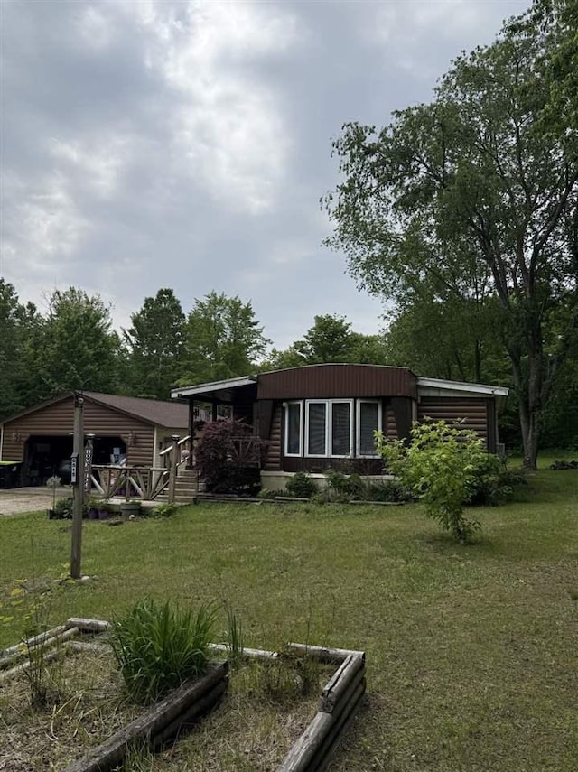 6515 Pincherry Rd, Charlevoix, MI 49720 - view of front facade featuring a front yard and a garage