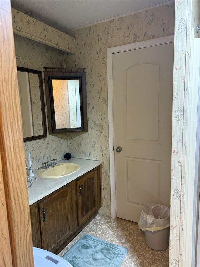 6515 Pincherry Rd, Charlevoix, MI 49720 - bathroom featuring vanity and wallpapered walls