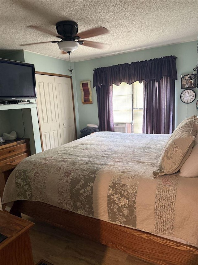 6515 Pincherry Rd, Charlevoix, MI 49720 - bedroom featuring a textured ceiling, a closet, wood finished floors, and ceiling fan
